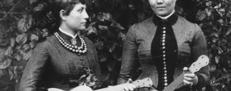 Maria Lane of Honolulu and friend pose with five-string taropatches strung as ukuleles, ca. 1891–1892