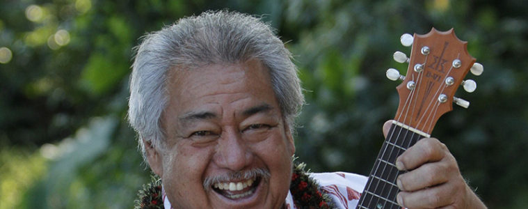 Hawaiian musician George Kahumoku holding a ukulele