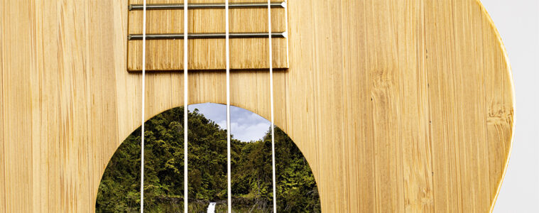 ukulele sustainability, lush green waterfall inside a bamboo ukulele soundhole photo illustration